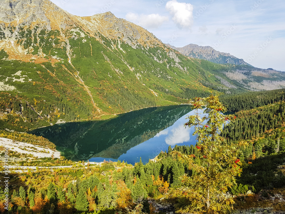 Beautiful crystal clear lake in high mountains, Beautiful Morskie Oko green water alpine lake on sunny day, Tatry Mountains (High Tatras), Poland