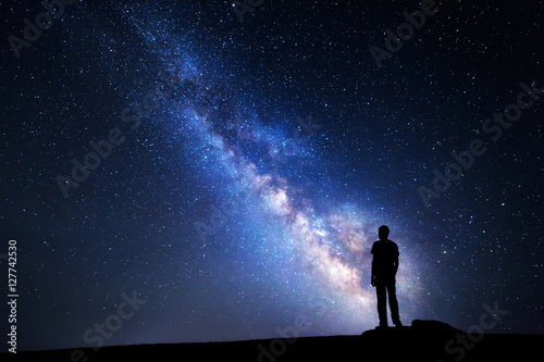 Milky Way. Night sky and silhouette of a man