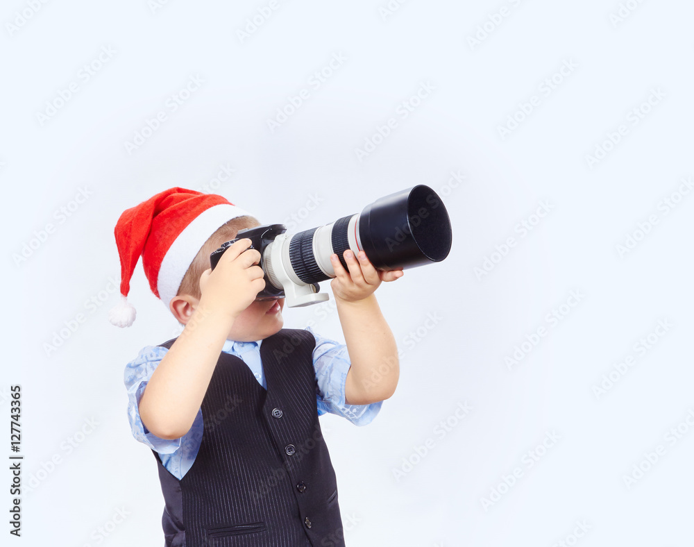 Little photographer is photographing on camera