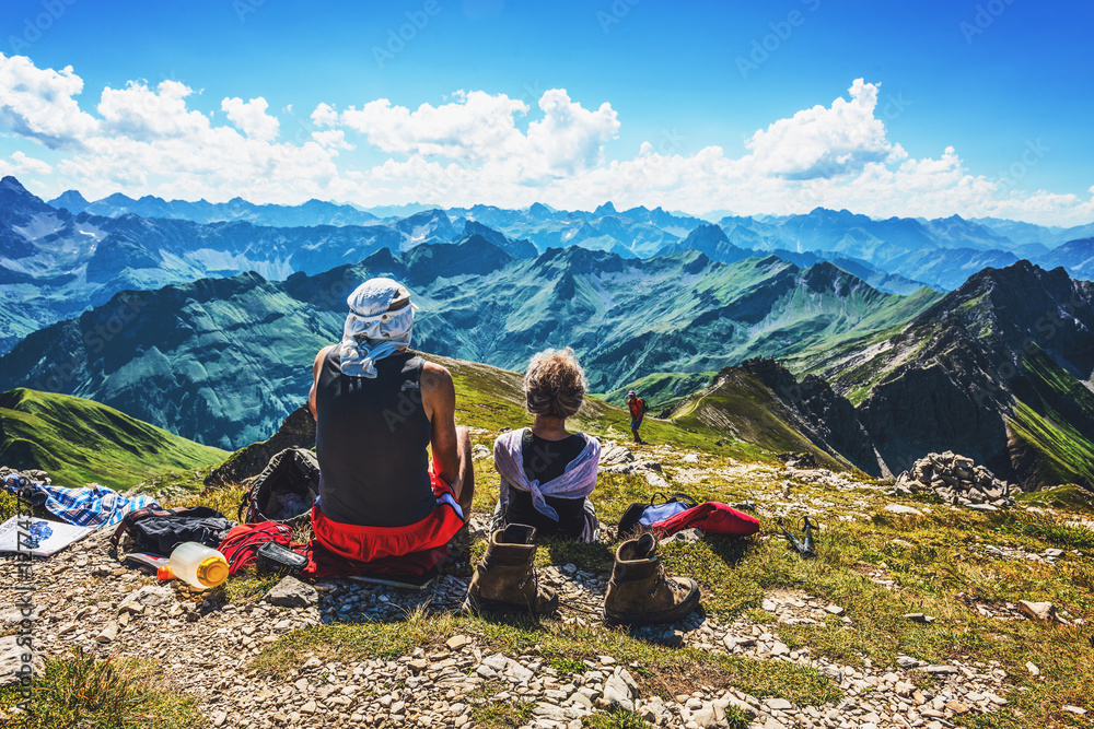 Pair of hikers resting near summit of mountain