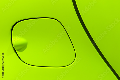 Petrol cap cover of bright green sport sedan car, side part with door of vehicle bodywork, auto industry photo