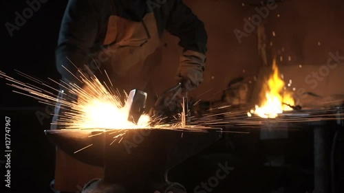 Forging hot metal in smithy
