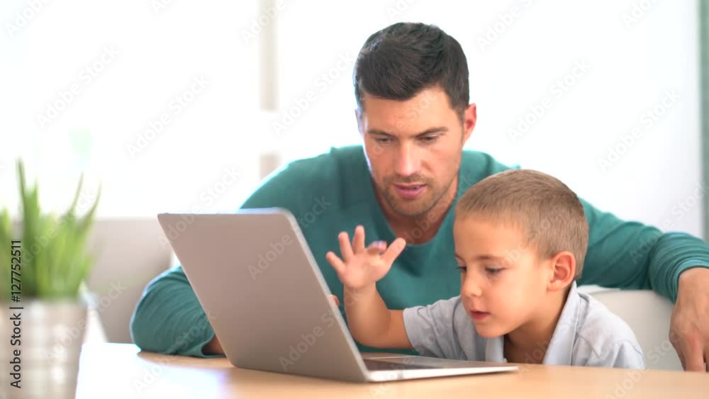 Daddy with kid using laptop computer for e-learning Daddy with kid using laptop computer for e-learning
