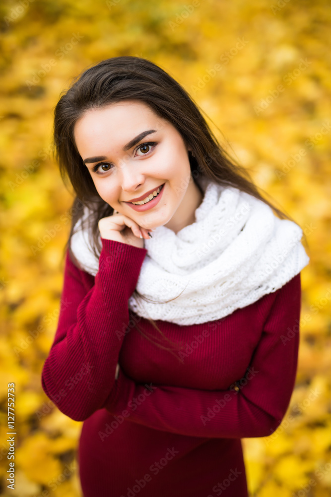 Beauty girl outdoors in autumn forest with yellow leaves from above Beauty girl outdoors in autumn forest with yellow leaves from above