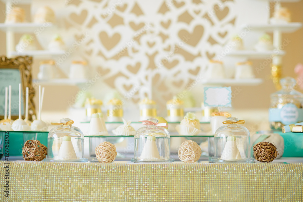 Delicious cakes in glass vessels at the festive candy bar