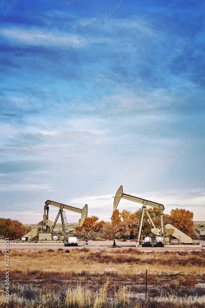 Retro toned picture of two oil pumps. Retro toned picture of two oil pumps.