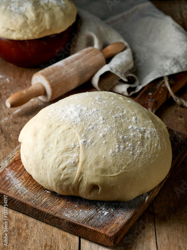 fresh raw dough on wooden table
