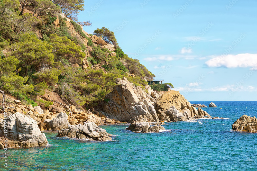 Beautiful natural rock near of Tossa de Mar, Costa Brava, Spain. Bay and crystal clear water of Mediterranean Sea. Amazing blue green sea and sunny day.