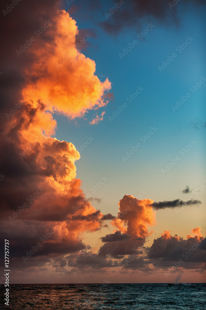 Beautiful sunrise with burning cloudscape over the sea