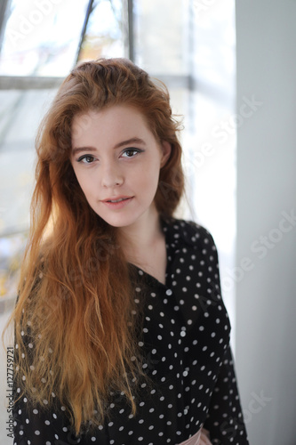 Red Haired Woman in Black Polka Dot Top