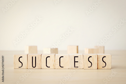 Sucess word on wooden cubes background