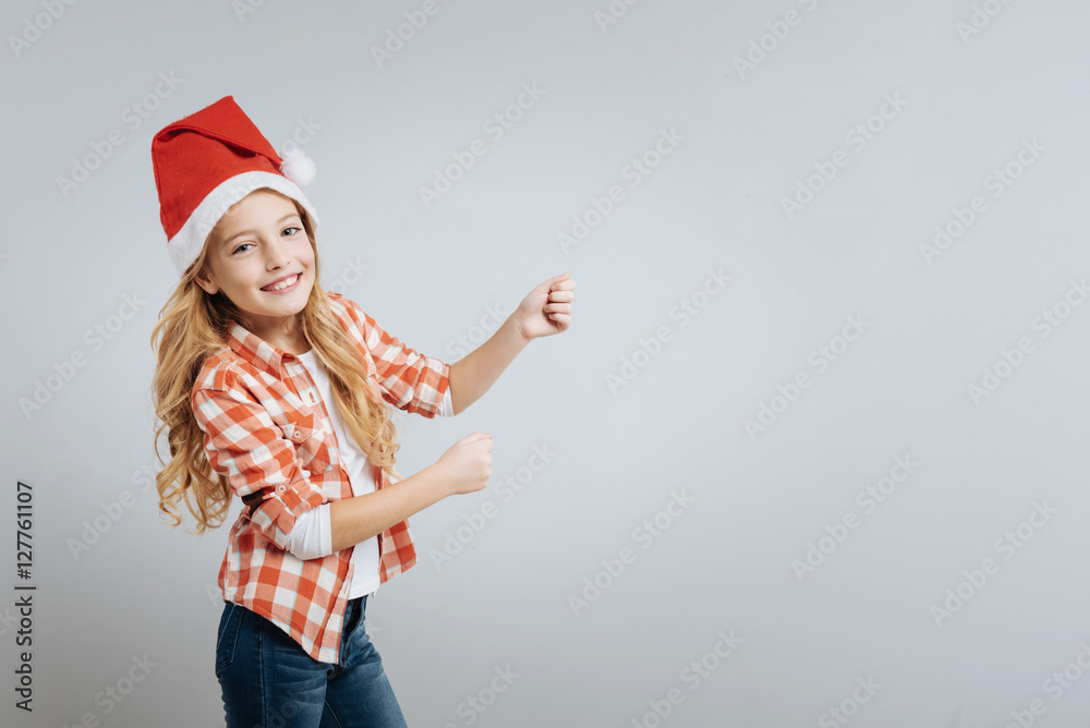 Joyful cute girl standign isolated on grey background Joyful cute girl standign isolated on grey background