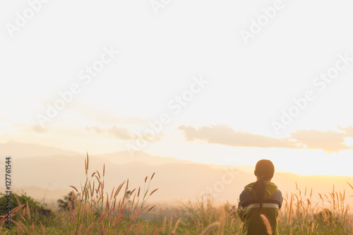 standing on a mountain, enjoying the sunset