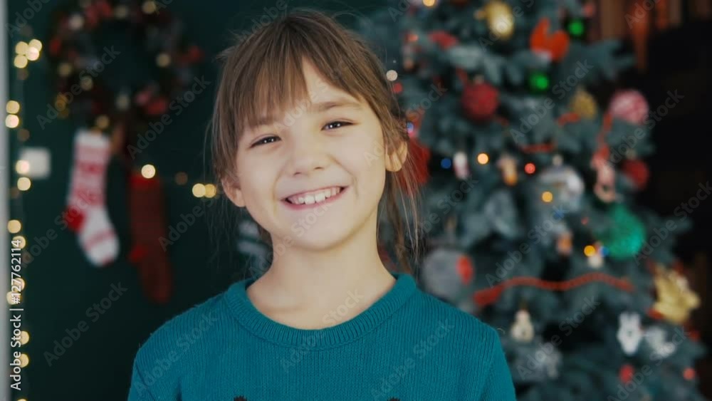 Portrait of a young kid girl smiling before christmas tree background Portrait of a young kid girl smiling before christmas tree background