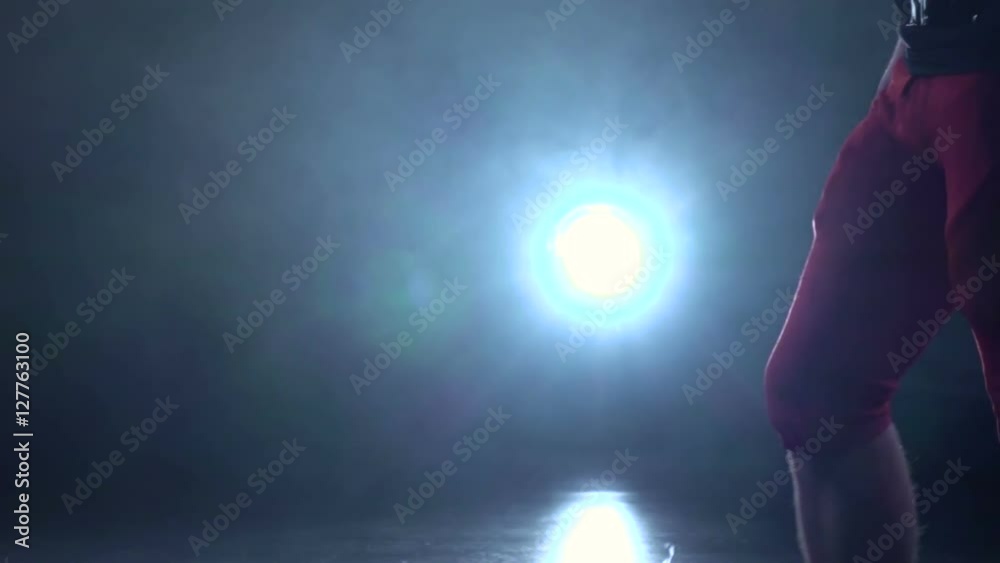 Football is a red helmet in his hand. Black background. Slow motion Football is a red helmet in his hand. Black background. Slow motion