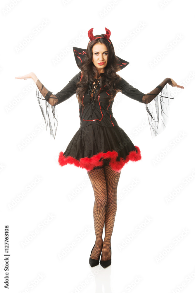 Full length woman standing with open gesture wearing devil clothes Full length woman standing with open gesture wearing devil clothes