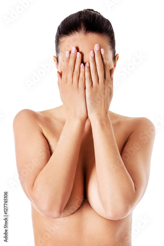 Young woman covering her face with her hands.