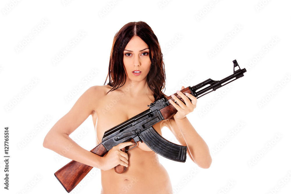 Sexy nude brunette girl model with weapon.
