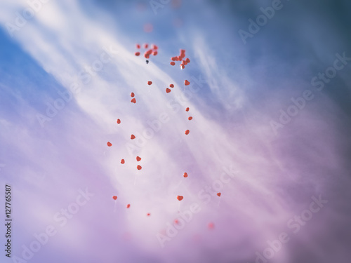 Countless red love balloos flying to heaven against sky background