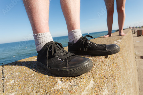 Male feet wearing sneakers outdoor