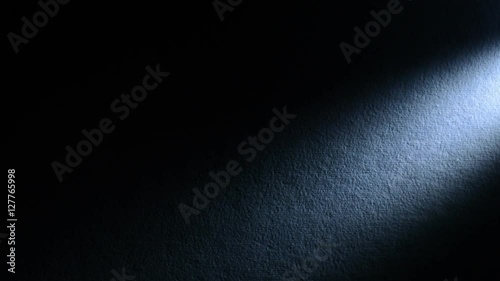 Lighting spotlight ture leaf dark background. A spotlight illuminates the wall on the right side. Full HD 1080p photo