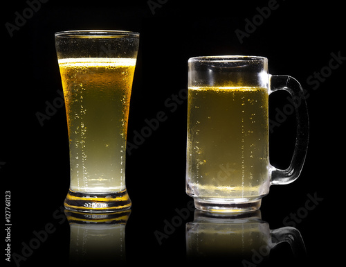 dual or two frosty lager light beer in clear glass set with stea photo