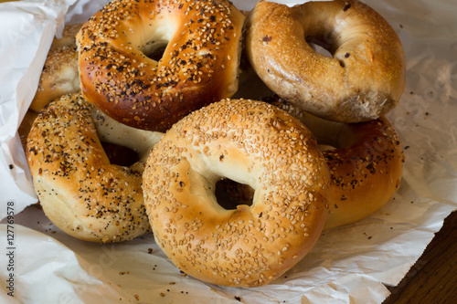 Variety of Authentic New York style bagels with seeds in a paper bag