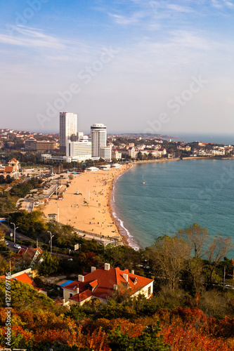 View of bathing beach N1 from the hill of Xiao Yu Shan Park in autumn, when the hill is covered in red leaves. Qingdao, Shandong province, China photo