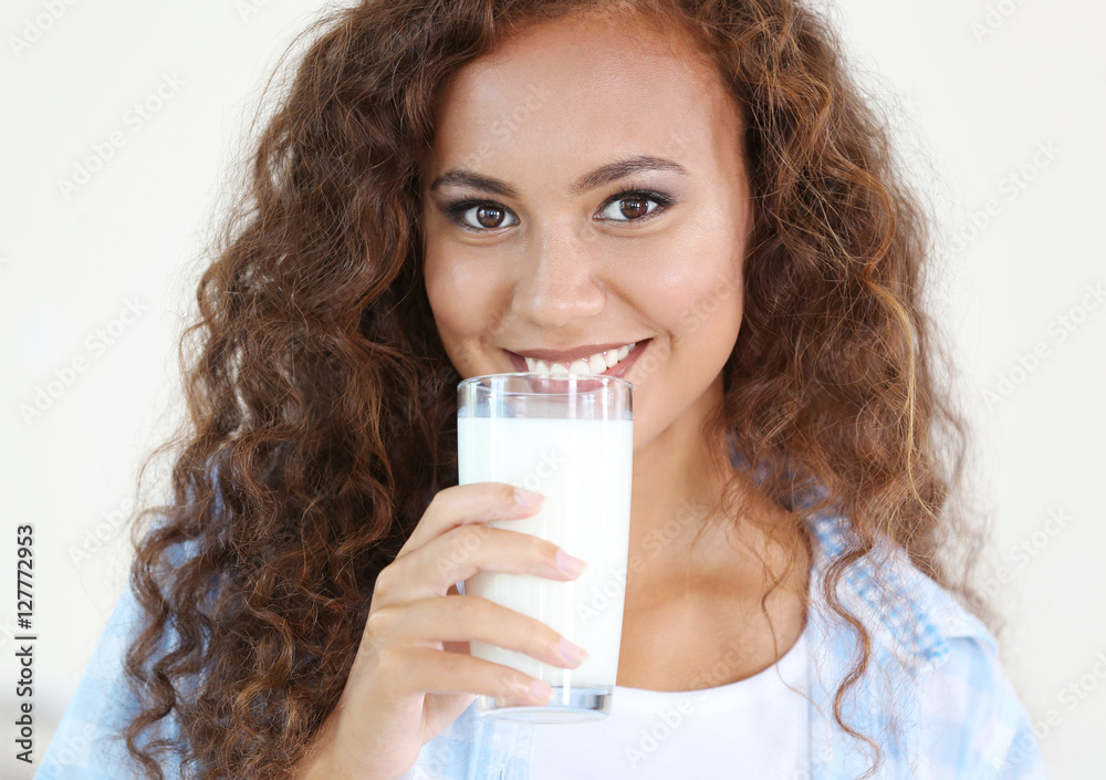 Beautiful young African-American woman drinking milk Beautiful young African-American woman drinking milk
