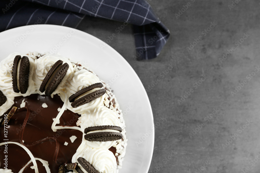 Plate with delicious chocolate cake on dark table, close up view