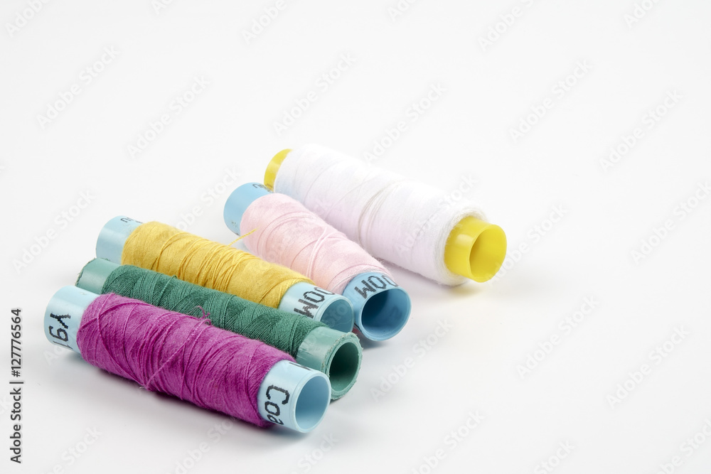 Sewing colored threads isolated on white background Sewing colored threads isolated on white background