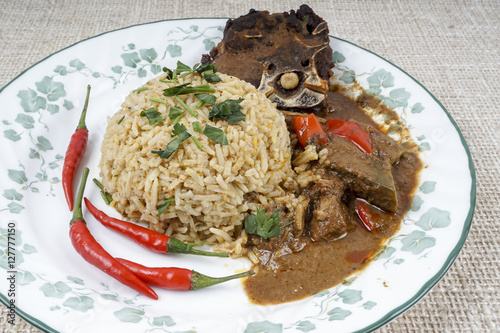 Mutton Byriani - Lamb and rice cooked with spices. Served with raita. Traditional South Asian Cuisine. photo