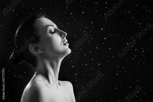 sensual aroused woman profile on stars sky background with copyspace monochrome