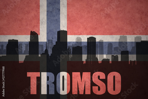 abstract silhouette of the city with text Tromso at the vintage norwegian flag