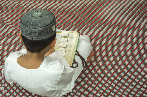 Boy reading Quran.