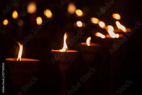 Traditional wooden torch flame at night photo