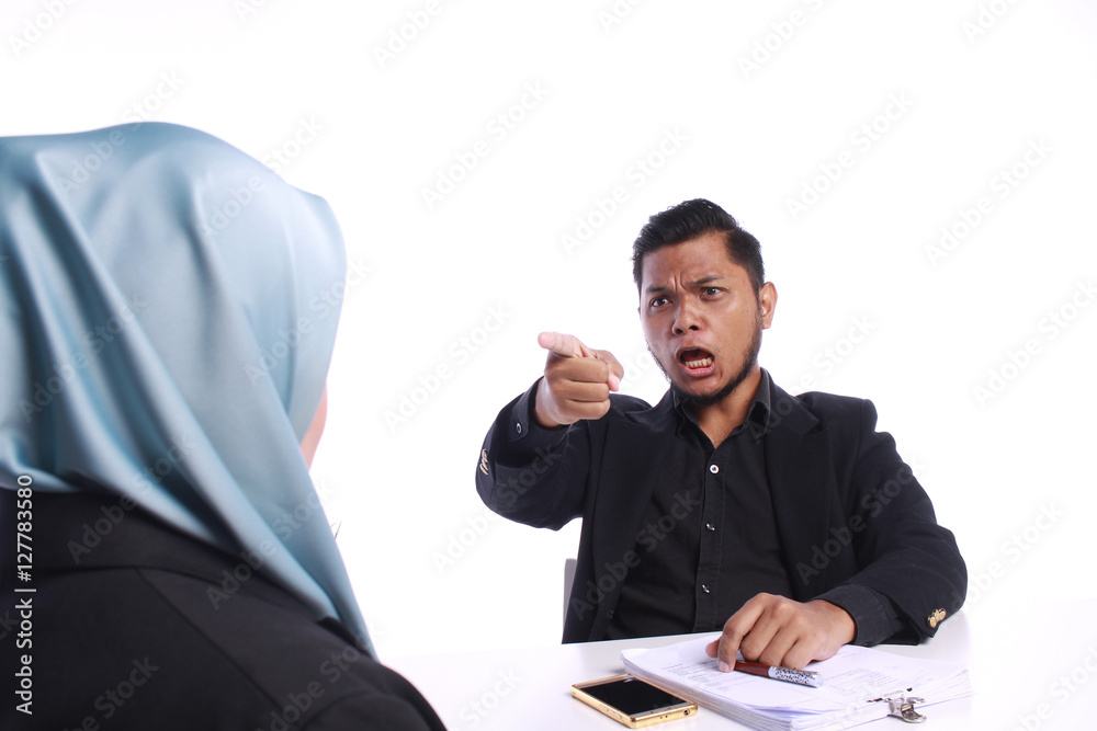 Angry businessman scolding his colleagues