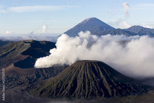 Wide angle view of Mount Bromo in Tengger Semeru National Park, East Java, Indonesia during beutiful sunrise with the valley full of sea cloud.