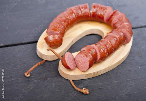 Traditional Dutch smoked sausage called Rookworst on wooden background