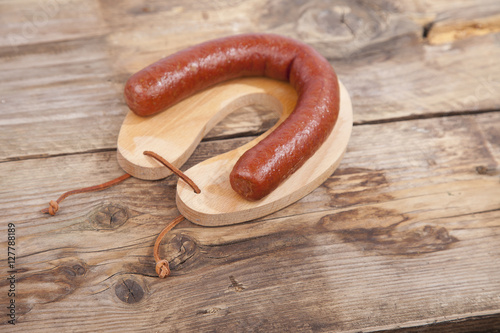 Traditional Dutch smoked sausage called Rookworst on wooden background