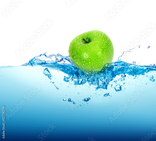 fresh green apple in blue Water splash with bubbles on white bac