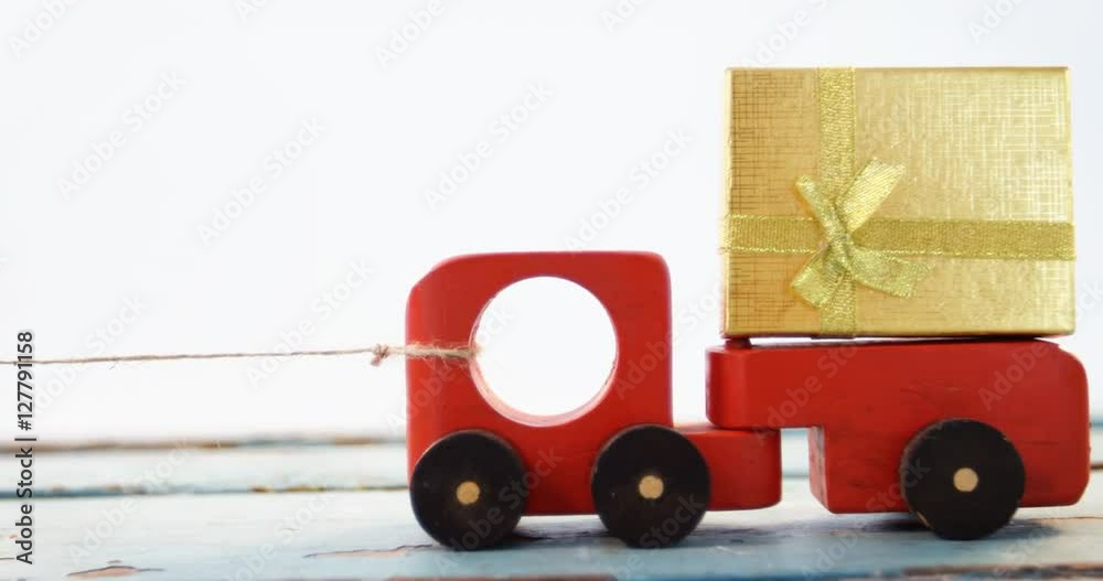 Toy tempo carrying christmas present against white background