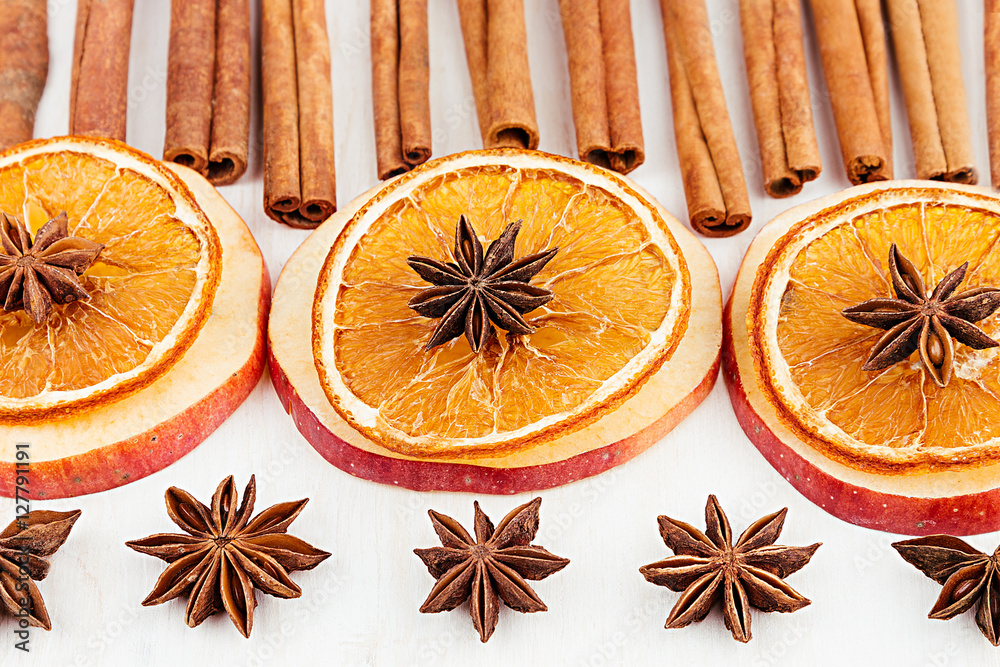 Christmas food - mulled wine background. Decorative frame of spice ingredients - anise stars, cinnamon, dried oranges and wine on wood white surface. Top view. Christmas food - mulled wine background. Decorative frame of spice ingredients - anise stars, cinnamon, dried oranges and wine on wood white surface. Top view.