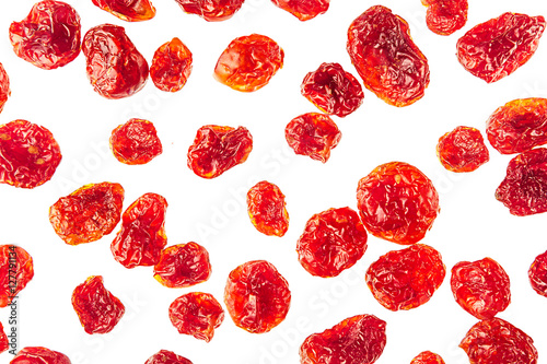 Dried cherries closeup on white background. Isolated. Pattern of glossy red cherry. Top view.