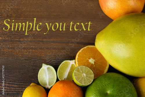 A variety of fresh tropical fruits on a wooden background.