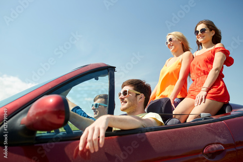 happy friends driving in cabriolet car © Syda Productions