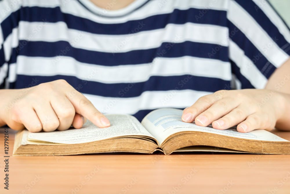 Woman reading book on the table Woman reading book on the table