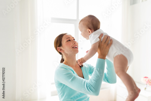 happy young mother with little baby at home