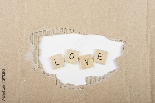 the word "love" through the hole in a carton