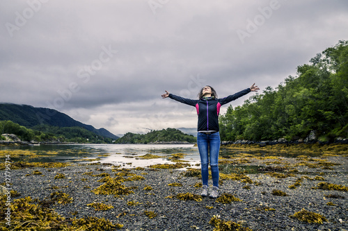 Young woman during the low-tide standing on the ground, Norway